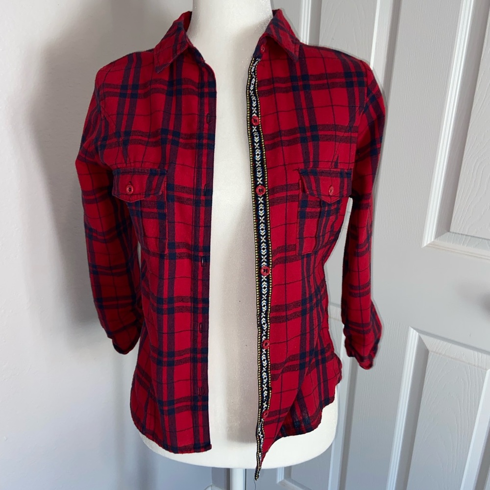 Red flannel with design strip on button opening